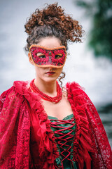 woman in red historic dress and masquerade