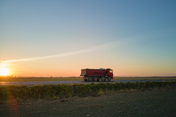Fototapeta premium Aerial view of cargo truck driving on highway hauling goods. Delivery transportation and logistics concept