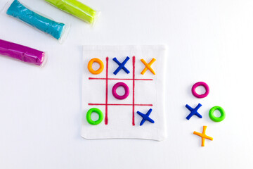 Tic tac toe game from colorful plasticine. DIY concept, simple handmade game.