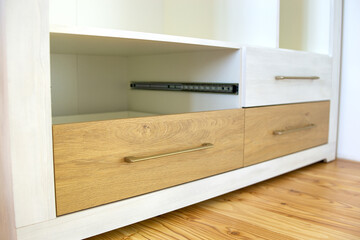 Close up of wooden drawer in contemporary cupboard cabinet.