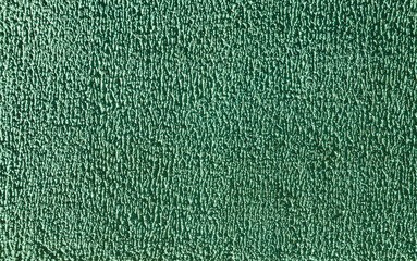 Rough stucco texture painted with green paint.