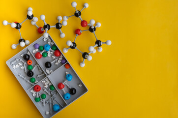 Top view of molecular atom models isolated on a yellow background