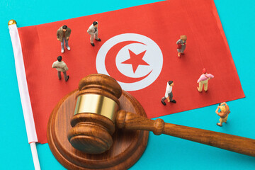 Judge gavel, Tunisian flag and plastic toy men on blue background, Tunisian society litigation...