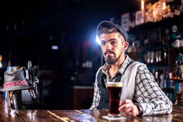 Professional bartender is pouring a drink in the bar