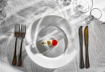 snack of cheese cubes and little cherry tomatoes on plate in restaurant table. Diet, weight loss, veganism.