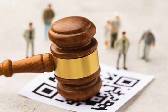 Judge gavel, barcode sheet and plastic toy men on abstract background, concept of administrative punishment for violation of the regime with QR code