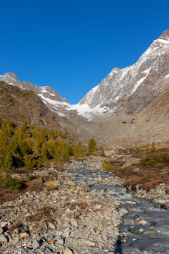 Beautiful autumn landscape with river and snow mountains