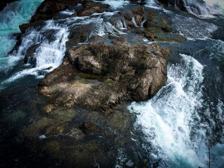Closeup shot of water flowing downstream on a rocky river