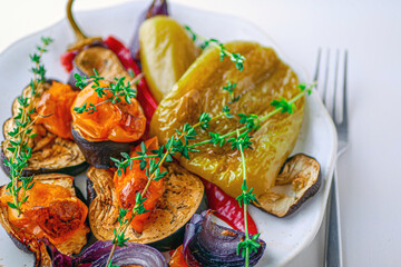 Baked vegetables peppers, eggplants, onions, tomatoes close-up, banner. Roasted vegetables background, vegan cuisine healthy food concept