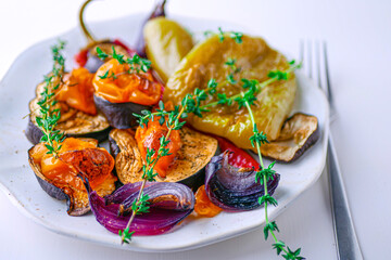 Baked vegetables peppers, eggplants, onions, tomatoes close-up, banner. Roasted vegetables background, vegan cuisine healthy food concept