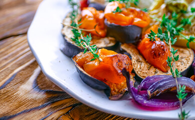 Baked vegetables peppers, eggplants, onions, tomatoes close-up, banner. Roasted vegetables background, vegan cuisine healthy food concept