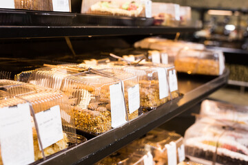 variety of sweet delicious cakes on the shop window of a cafe