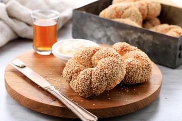 Crispy Turkish Traditional Bagel (Simit) with Sesame and Glass of Turkish Black Tea on Wooden Background, Turkish Breakfast Pastry Concept
