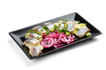 Appetizer with lightly salted herring, boiled potatoes and onions. Isolated on a white background