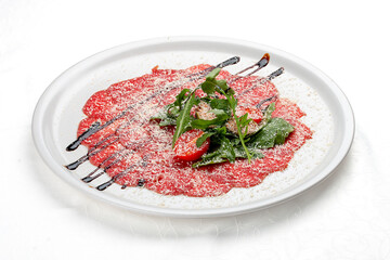 Veal carpaccio with parmesan cheese. Isolated on a white background