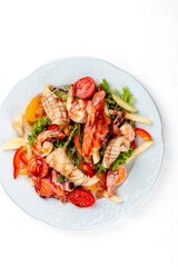 Salad Di Mare .Salad with shrimp, salmon and squid, orange and sweet pepper. Isolated on a white background