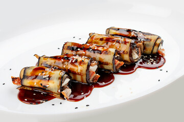 Eggplant rolls with eel. Isolated on a white background.