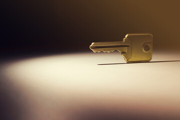 Illuminated key on a dark table. Soft focus