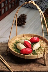 Red and White Traditional Chuseok Day Food, Korean Half Moon Shaped Rice Cake or Songpyeon. Made from Korean Rice Flour with Sesame Seed or Chopped Nuts, Honey, or Red Bean Paste,