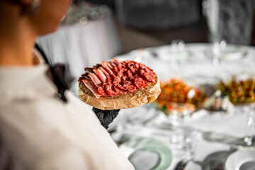 waiter holds tray with food. Restaurant service. buffet or catering.