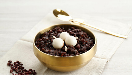 Korean Food Patjuk or Red Bean Porridge Topped with Round Rice Cake, Eat at Winter Solstice Festival