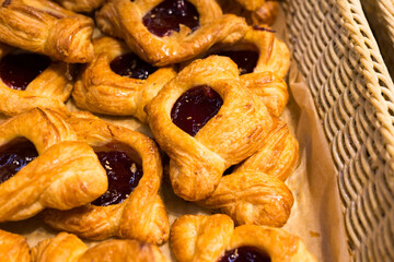buns with marmalade filling in baskets in bakery