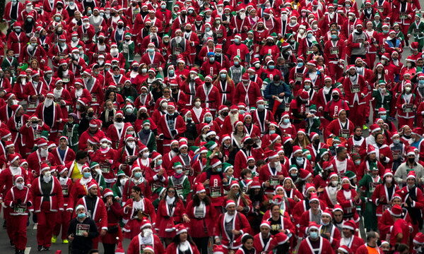 People dressed as Father Christmas get ready to run on Madrid's main avenue Paseo de La Castellana