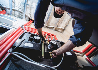 HVAC technician servicing home heating and cooling system