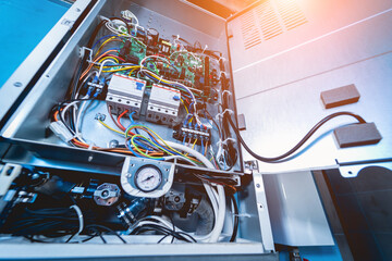 Open air conditioner unit with wires, pipes and electrical equipment