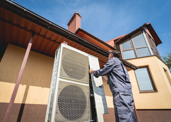 HVAC technician servicing home heating and cooling system