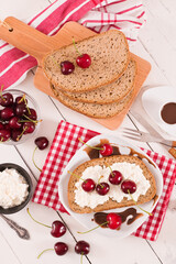 Rye bread with cottage cheese and cherries.