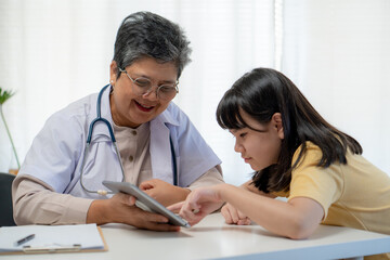 Fototapeta premium The doctor gives the young patient the results of the examination with a computer tablet.