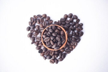 coffee beans on a wooden bowl with love shape