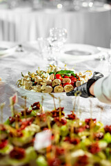 waiter holds plate with food. Restaurant service. buffet or catering.