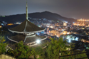 Lit up three-storied pagoda in Tenneiji Temple and Onomichi City view at night, Hiroshima,...