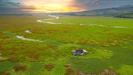 High angle view a single house in the middle of a meadow in Wetlands. A house surrounded by rivers and meadows