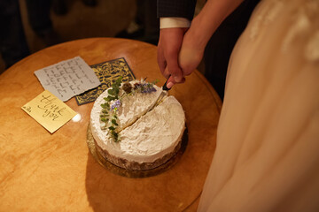 bride and groom cut a wedding cake