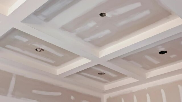 Laid plastering gypsum on the walls and ceiling to drywall seams of ready for paint a newly built house