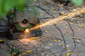 Electric circular steel cutting machine and sparkle.  workers use tools to cut steel for building up and sparks from real-world situations. Worker Cutting steel