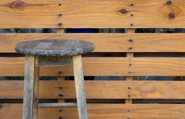 Front view of old, vintage and grunge wooden wall including chairs with beautiful surface texture of weathered materials. It can be used for outdoor abstract background and backdrop.