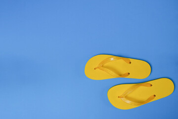 Summer mock-up flip flops on a blue background. Summer vacation concept. Top view, flat lay. 
