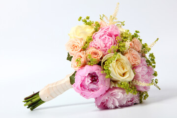 Bridal bouquet of several varieties of roses on a white background