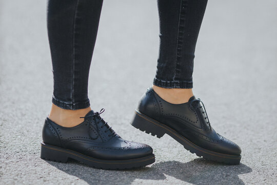 Legs Of A Female Wearing Fashionable Black Loafers