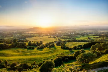 Fototapete Beige Sunset over green fields of Gloucestershire viewed from Crickley Hill.  © Trevor Woodville