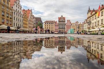 Fototapeta na wymiar Wroclaw, Poland - due to the frequent rain, in Wroclaw you can easely find water pools, and use them to make nice shots. Here in particular the mirror effect in the Old Town