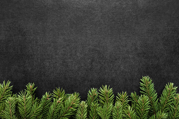 Fresh green fir branches on dark table background. Condolence card. Empty place for emotional, sentimental text, quote or sayings. Closeup. Top down view. - obrazy, fototapety, plakaty