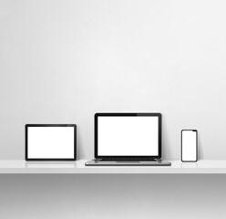 Laptop, mobile phone and digital tablet pc on white concrete wall shelf. Square background