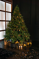 Classical Christmas decor. New year. Beautiful boxes with gifts near the tree. Dark background