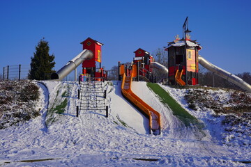 Children's playground  in a winter setting. Children's playground in a winter scenery. Family...