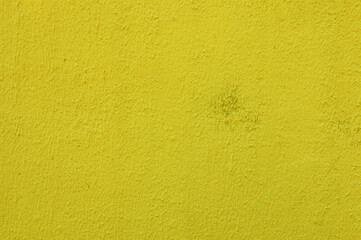Fototapeta premium Abstract background of yellow plaster on concrete wall.